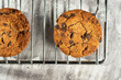 Homemade cookies with raisins, chocolate, nuts and milk on a wooden table and a art phone. Breakfast. Close up.