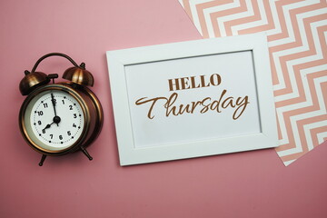 Wall Mural - hello thursday and alarm clock on pink background