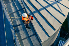 Top View Of An Industry Worker Standing On Height And Checking On Silo Supply.