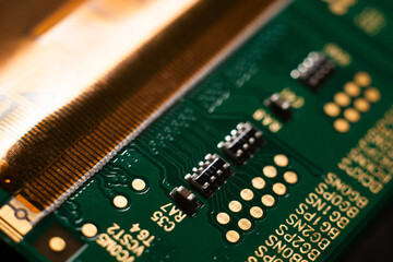 Canvas Print - Macro photo of a green computer printed circuit board with selective focus on electronic components