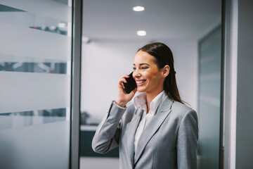 Wall Mural - A businesswoman having business call at the office.