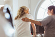 © Maskot - Female caregiver talking with elderly woman exercising on treadmill at retirement home