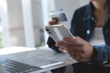 Wall Mural - Close up of woman using credit card and mobile smart phone for digital banking and online shopping via mobile app at home, smart banking, internet payment, business and technology, e-commerce