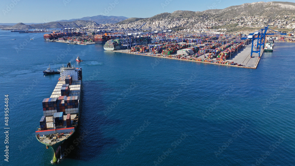 Aerial drone photo of container vessel leaving industrial loading ...