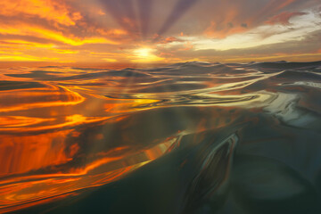 Wall Mural - beautiful seascape of the setting sun reflecting the rays of the wave.
