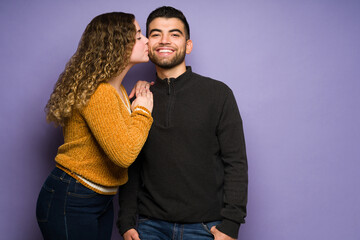 Romantic girlfriend kissing her partner