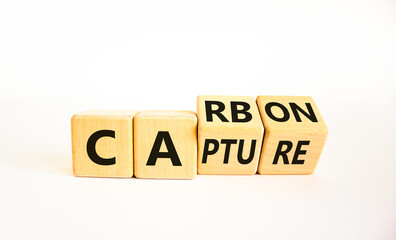 Wall Mural - Carbon capture symbol. Turned wooden cubes and changed the concept word Carbon to Capture. Beautiful white table white background. Business ecological carbon capture concept. Copy space.