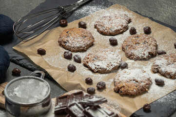 homemade chocolate cookie dressed with sugar and black background.