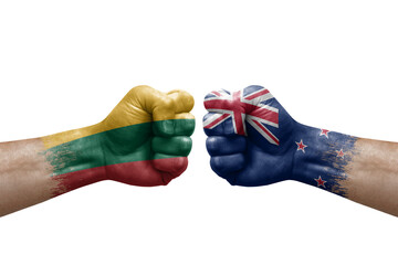 Two hands punch to each others on white background. Country flags painted fists, conflict crisis concept between lithuania and new zealand