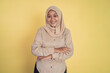 © Odua Images - young muslim woman stand with crossed hands on isolated background