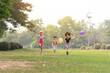 © rachaphak - Small group of a happy children run through the park in the background of grass and trees. Children's outdoor games, vacations, weekend, Children's Day