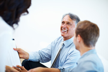 Male advisor with clients. Happy male advisor showing financial plan to clients.