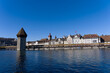 © Michael Derrer Fuchs - Medieval old town of Luzern with famous covered wooden Chapel Bridge (German: Kapellbrücke) and stone water tower on a sunny winter day. Photo taken February 9th, 2022, Lucerne, Switzerland.