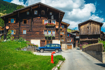 Wall Mural - Orderly street with traditional old wooden houses in Switzerland