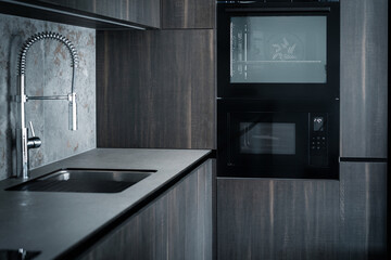 Wall Mural - Modern dark grey kitchen design - detail of interior with steel faucet and home appliances