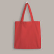 Red blank cotton eco tote bag, design mockup. Shopping bag hanging on wall
