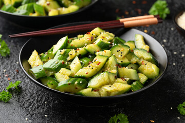 Smashed cucumber spicy Asian style salad with soy sauce dressing, chilli flakes, garlic and sesame seeds