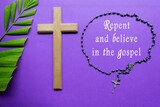 Fototapeta  - Cross and palm leaves with text on purple background. Holy week concept.