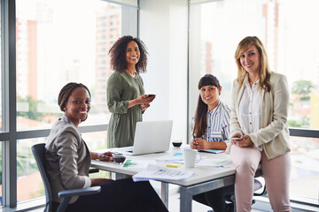 Poster - The table of powerful women working hard in the business. Cropped shot of a group of businesswomen having a meeting in the office.