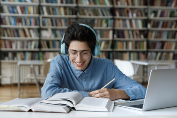 happy motivated millennial jewish male student in glasses favorite music in headphones, feeling exci