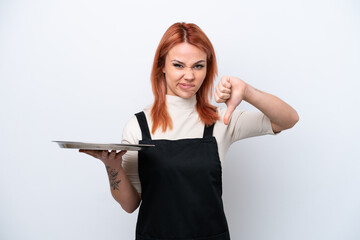 Wall Mural - Young Russian waiter with tray isolated on white background showing thumb down with negative expression