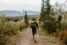 Canada, Yukon, Whitehorse, Rear View Of Man Hiking In Mountain Landscape