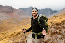 Canada, Yukon, Whitehorse, Portrait Of Smiling Hiker In Mountain Landscape