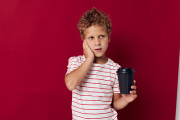 Wall Mural - boy with curly hair black glass with drink posing