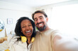 © CarlosBarquero - Cheerful selfie at home mixed race couple smiling and looking at camera. Happy man and beautiful woman taking self photo and having fun