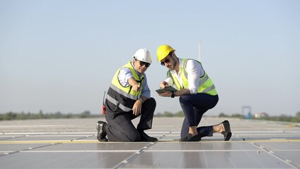 Wall Mural - professional engineer using drone and digital tablet maintaining solar cell panels together on build