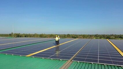 Wall Mural - professional engineer using drone and digital tablet maintaining solar cell panels together on build