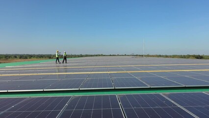 Wall Mural - professional engineer using drone and digital tablet maintaining solar cell panels together on build