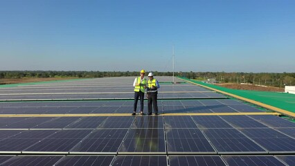Wall Mural - professional engineer using drone and digital tablet maintaining solar cell panels together on build