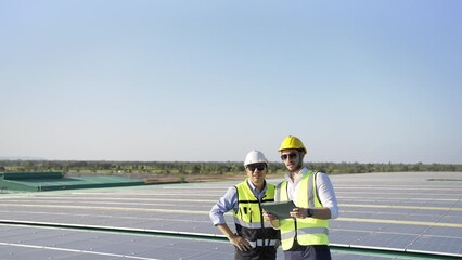Wall Mural - professional engineer using drone and digital tablet maintaining solar cell panels together on build