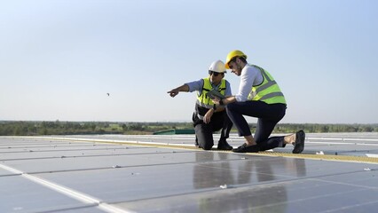 Wall Mural - professional engineer using drone and digital tablet maintaining solar cell panels together on build