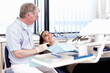 © Stigur/peopleimages.com - Doctor speaking to his patient. Portrait of mature doctor speaking to his patient in clinic.