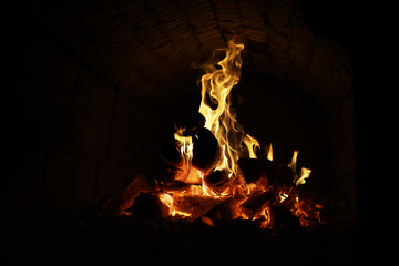 Wall Mural - Background of the flame in the oven. Tongues of fire in a brick fireplace. Fire texture.