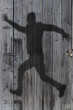 human shadow in a wooden door