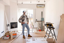 Young Man With VR Glasses Looking At Home Renovation