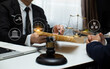 © SOMKID - Concepts of Law and Legal services. Lawyer working with law interface icons. Blurred background.