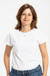 © Westend61 - Smiling woman standing with hands in pocket against white background