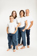 © Westend61 - Boy with parents and sister standing hands in pocket against white background
