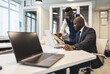 © xartproduction - Two African American business partners are working on a laptop together on a joint project. Mutual assistance and establishment of social contacts