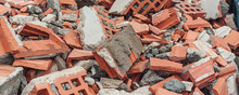Construction Debris Red Brick From Demolished Building Wall In Waste Dumpster Closeup