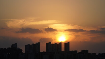 Wall Mural - the beautiful sunset view with the colorful clouds and sky in the city