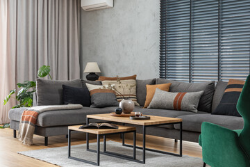 Poster - Stylish composition of elegant living room interior with grey corner sofa, coffee table and stylish personal accessories. Modern home decor. Panoramic windows. Template.