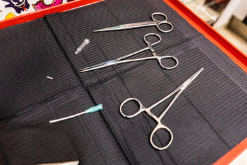 used piercing material. disposable material and tweezers. body piercing and jewellery setting tools.