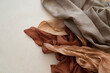 hand dyed clothes in warm natural tones hanging on a bright background - text space -
slow fashion concept 