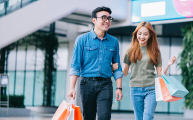 Wall Mural - Asian couple shopping at the mall