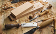 Woodworker. Timber, wood processing. Joinery work. Wood carving with work tools close up. Hand of carver carving wood. Craftsman carving with a gouge